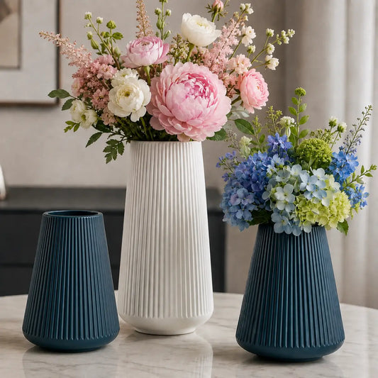 Floreros decorativos estriados en colores azul y blanco con arreglos de flores
