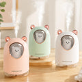 Humidificador con diseño de oso y luz LED disponible en colores rosado, verde y blanco