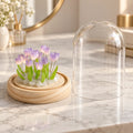 Lámpara decorativa de tulipanes con cúpula transparente colocada sobre una mesa