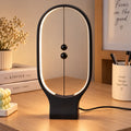 Lámpara LED magnética de mesa con diseño ovalado negro y dos esferas suspendidas
